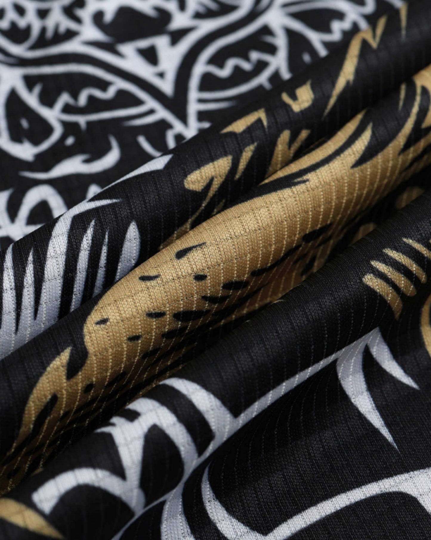 Real Madrid Emperor's Armor football kit close-up of white and gold textured pattern