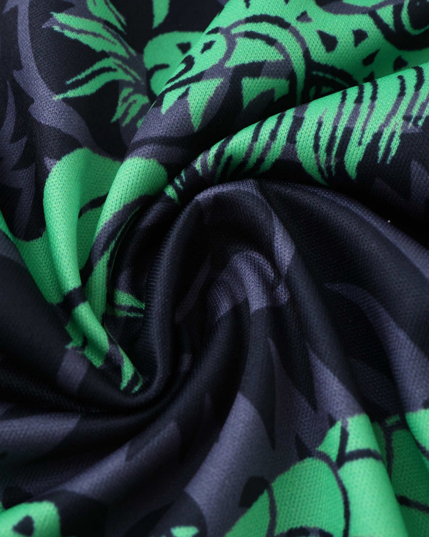 Close-up of green and black dragon print fabric on Real Madrid Green Falkor football jersey