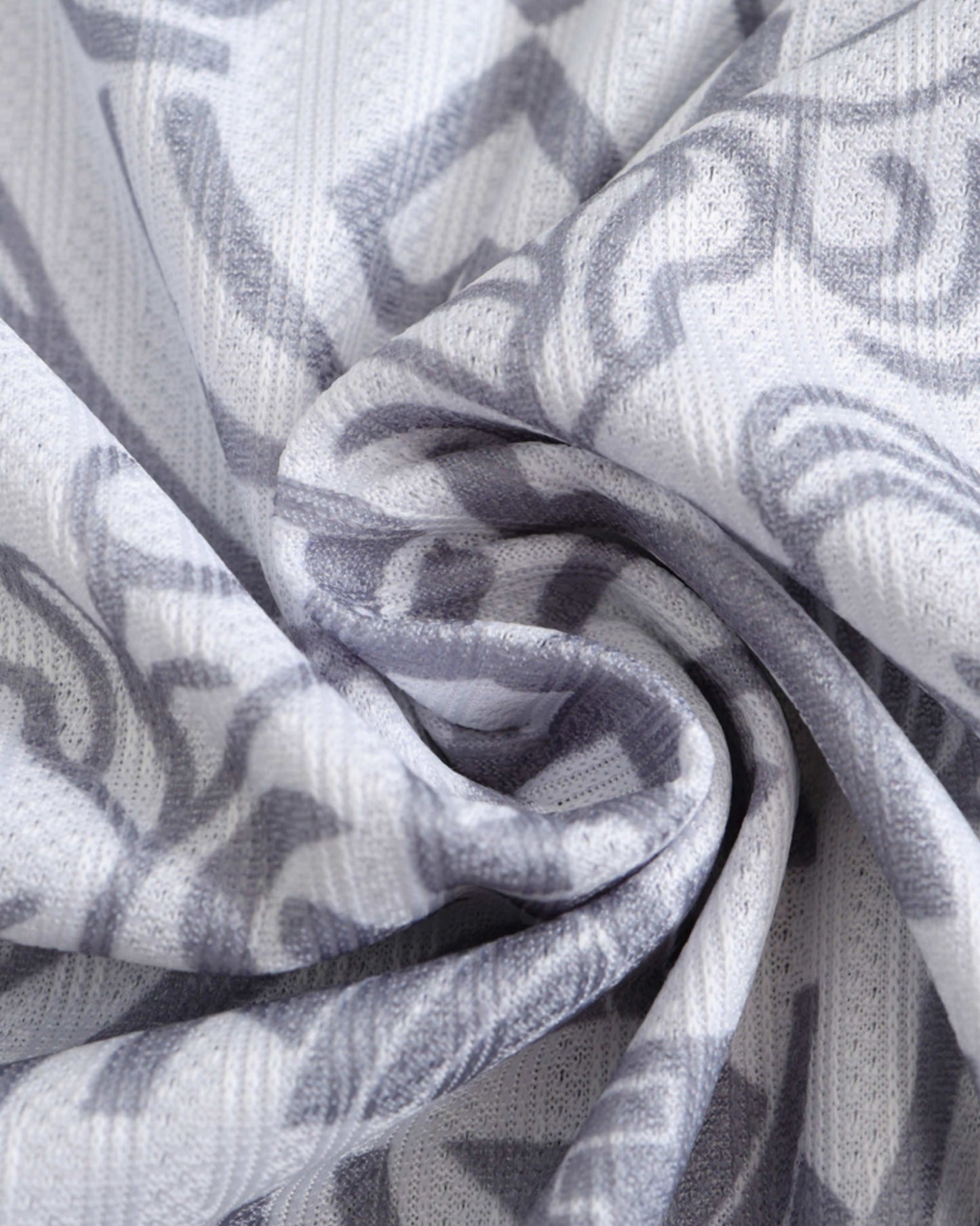 Real Madrid Imperial Elegance football jersey fabric close-up showing grey heraldic crest pattern