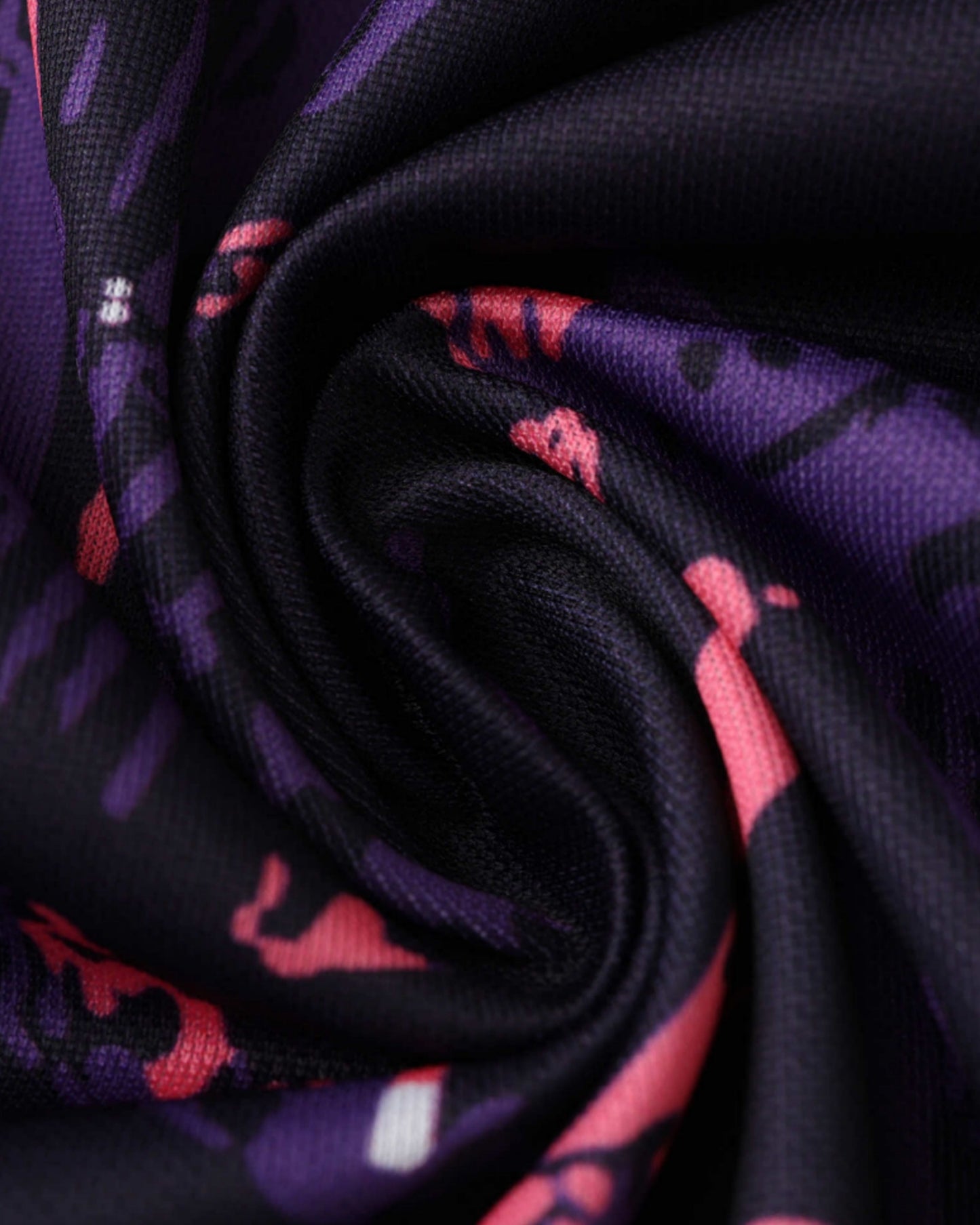 Close-up of purple and pink camo fabric of Real Madrid Madridista football jersey