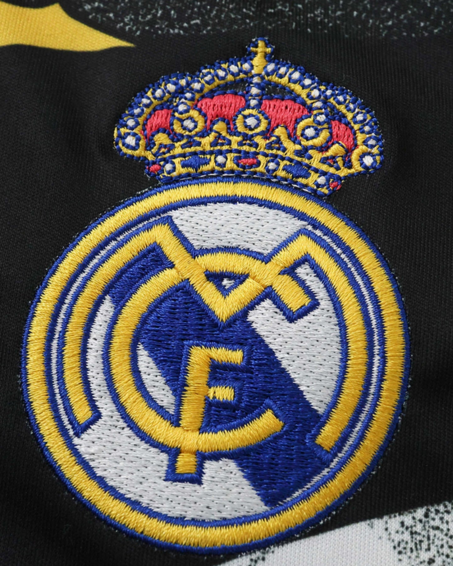 Real Madrid x Marvel football jersey close-up of embroidered crest and crown