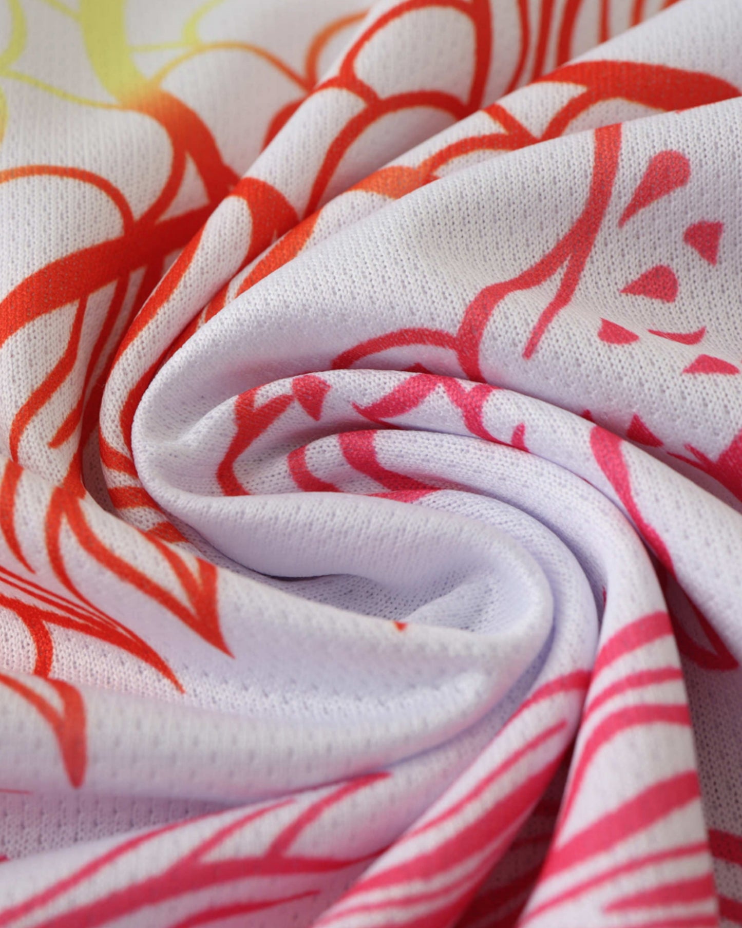 Close-up of white Real Madrid Dragón Blanco jersey fabric with rainbow dragon stripes