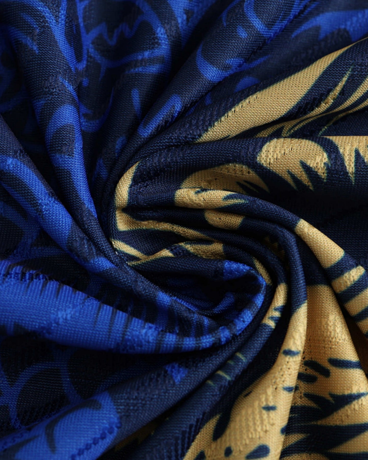 Close-up of the gold dragon artwork on the blue Real Madrid Year of Loong football jersey
