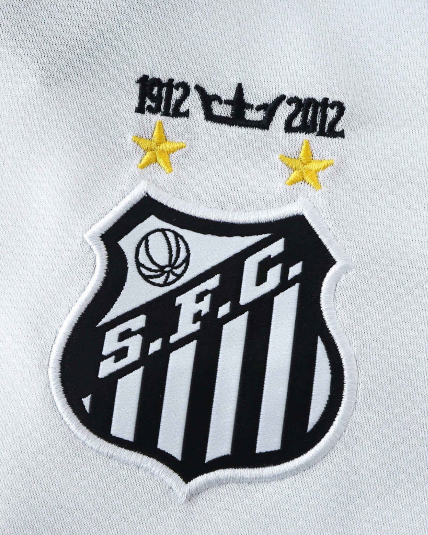 Close-up of black Santos FC crest with stars on white retro home kids football jersey 2013/14