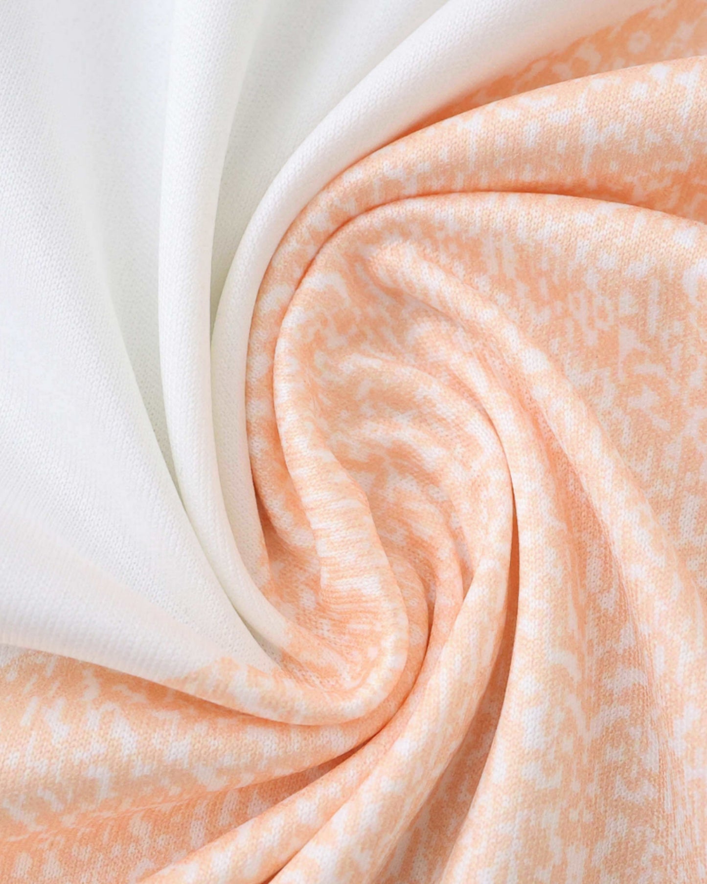 Spain away football jersey 2025/26 close-up of white and peach swirled fabric texture