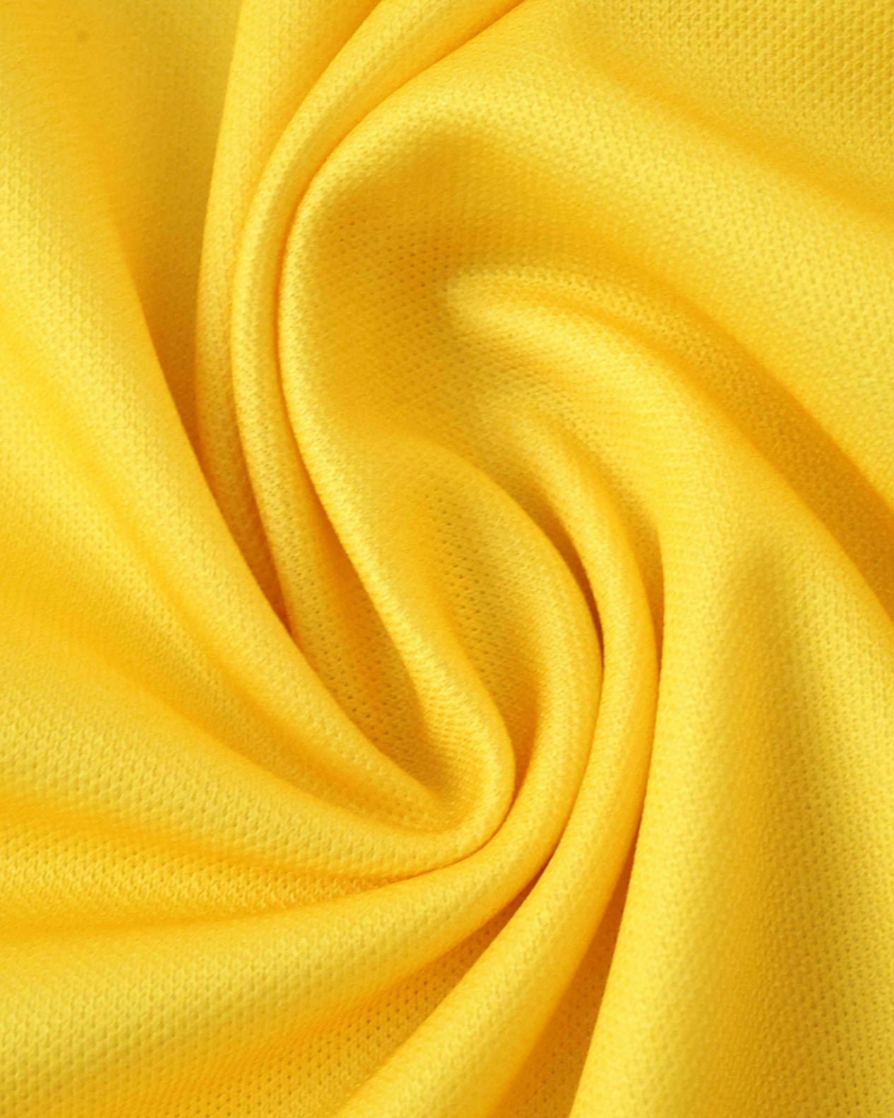 Yellow Tottenham Hotspur third football jersey 2025/26 fabric close-up showing textured weave
