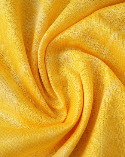 A close-up of a yellow, textured fabric with folds.