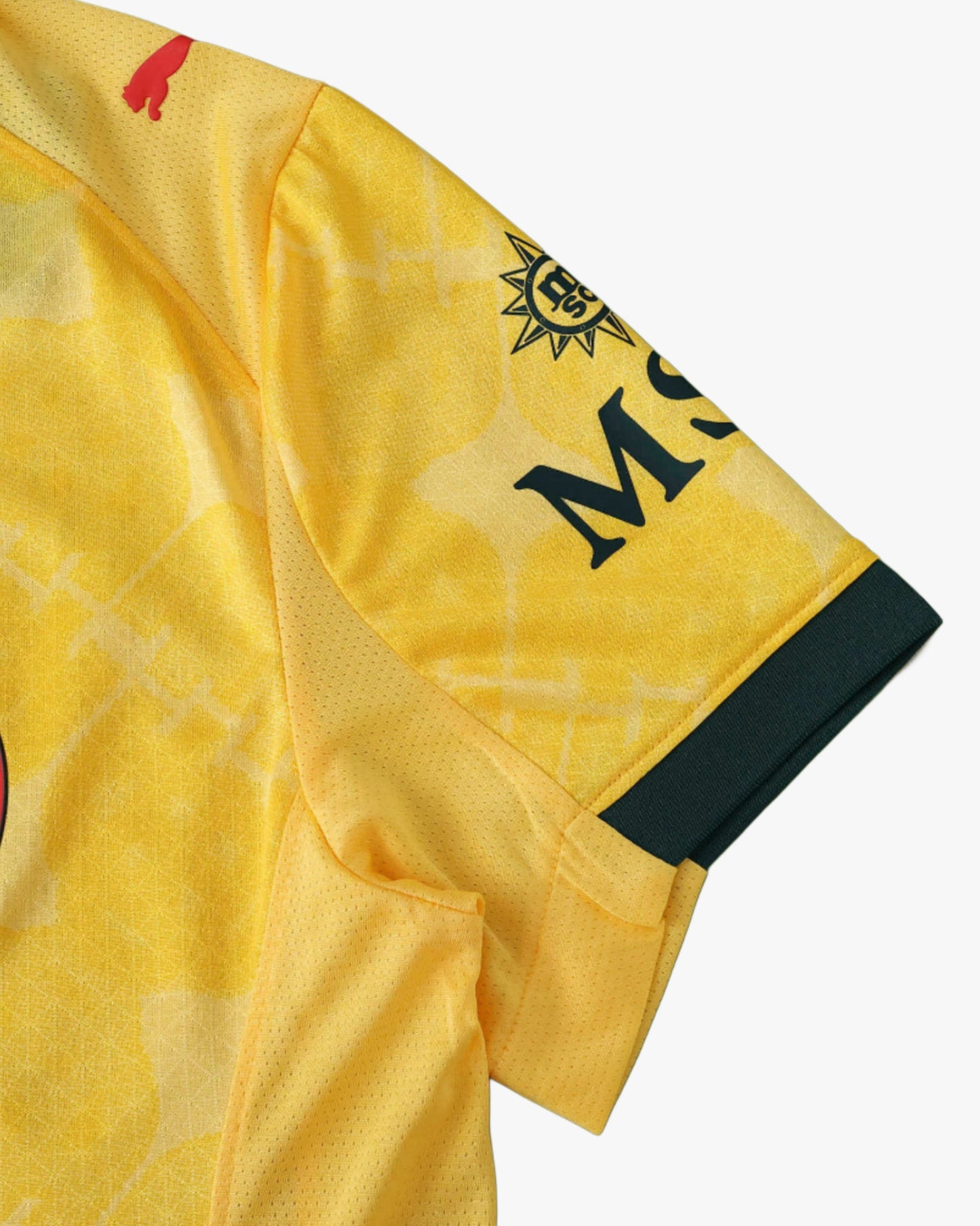 Yellow AC Milan 2025/26 football jersey with red Puma logo and dark green trim.