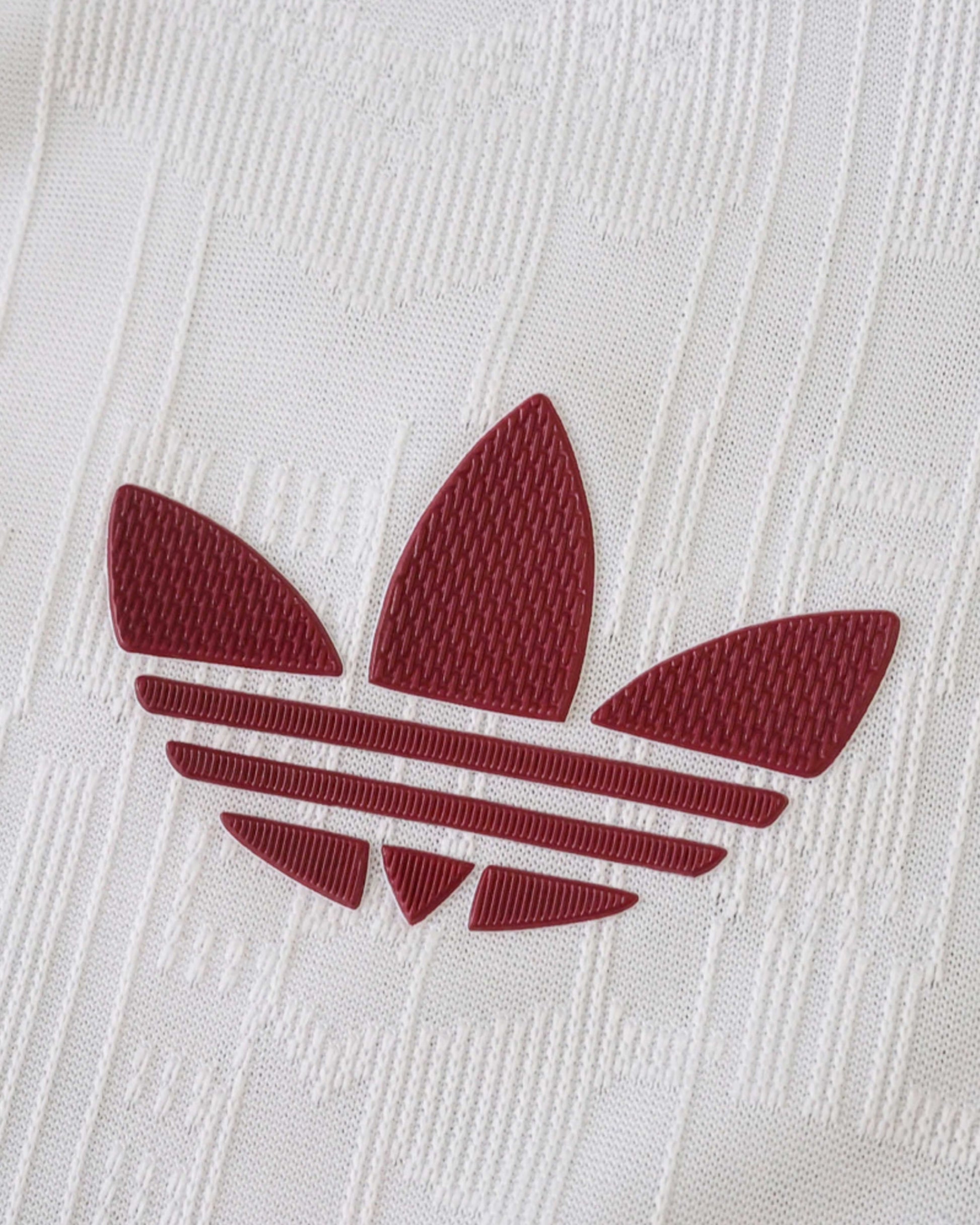 White Arsenal third kit jersey with a maroon Adidas logo.