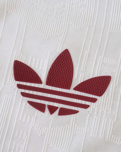 White Arsenal third kit jersey with a maroon Adidas logo.