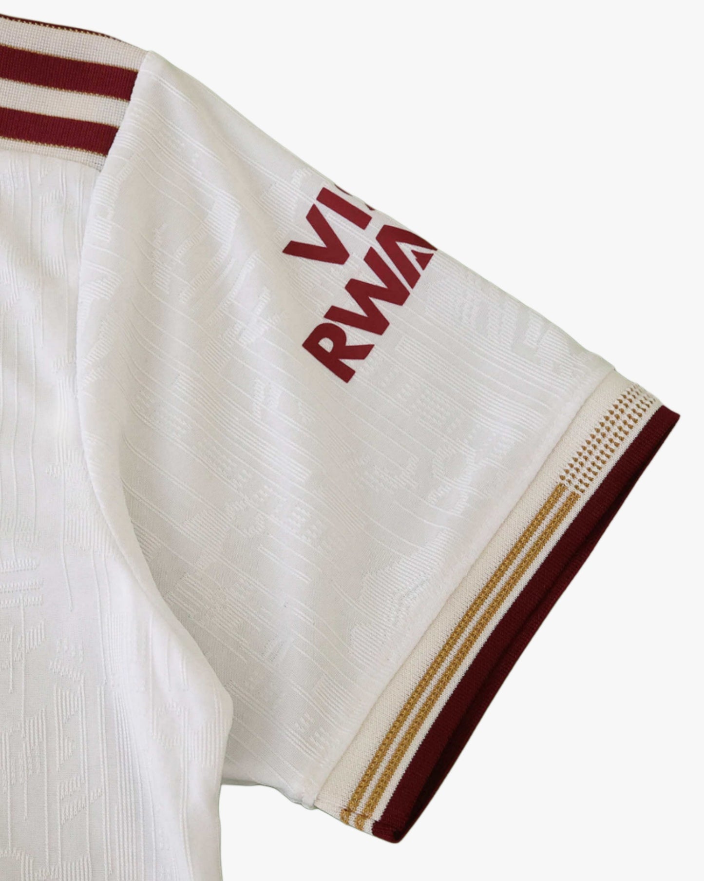 White Arsenal third kit jersey with maroon and gold trim and "VI RWA" text.