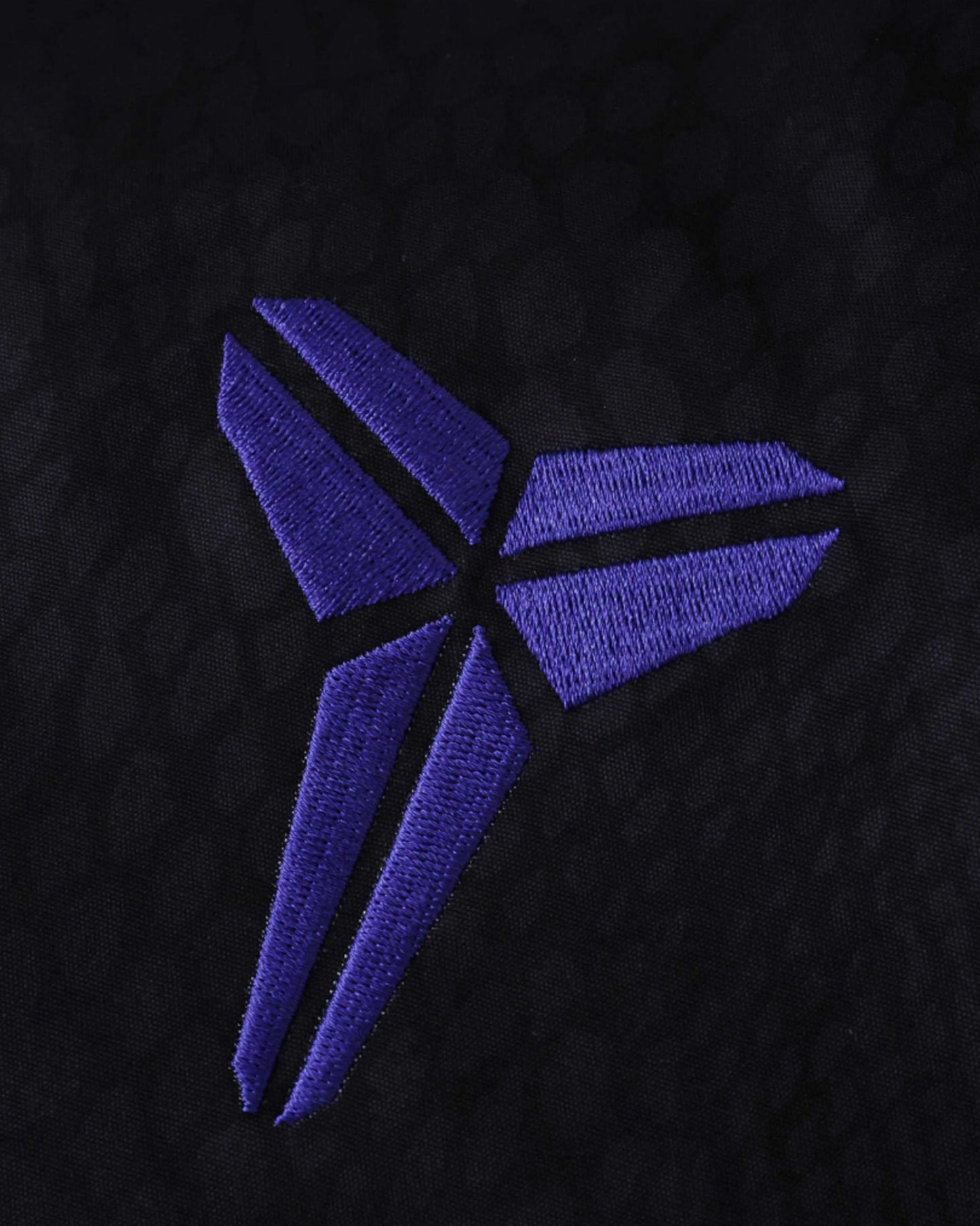 Footxo Barcelona Windbreaker 2025/26 with purple embroidered logo on black fabric.