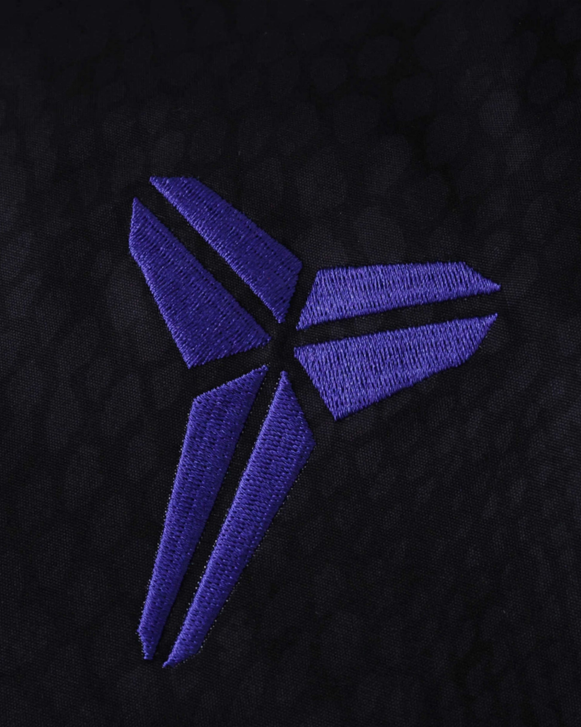 Footxo Barcelona Windbreaker 2025/26 with purple embroidered logo on black fabric.