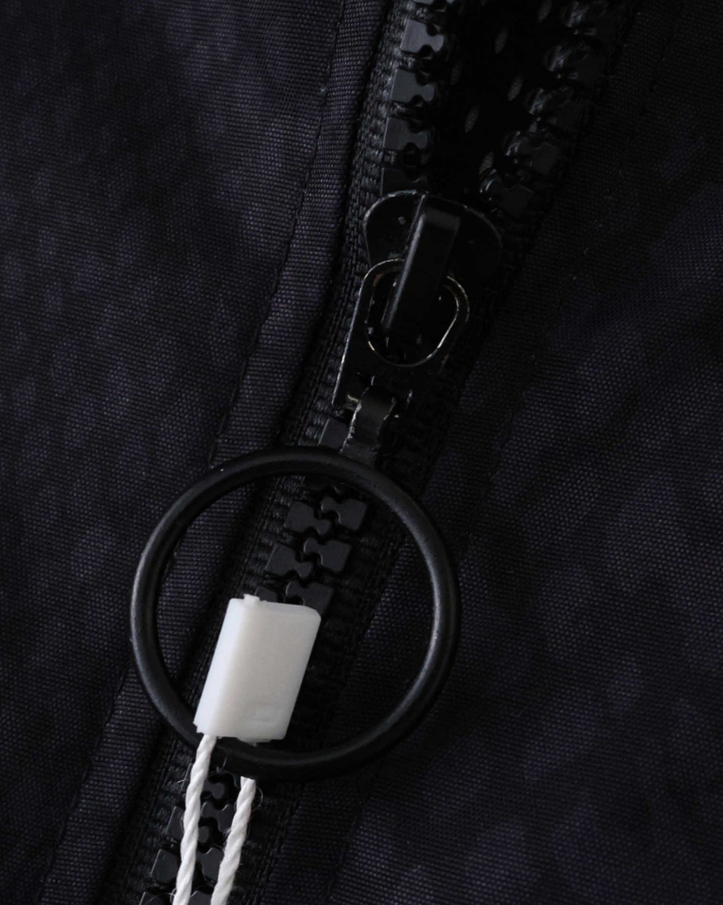 Black Footxo Barcelona windbreaker with a black zipper and ring pull.