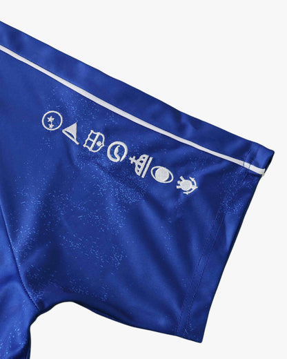 Brazil Commemorative football jersey close-up of gold CBF crest and four stars on royal blue fabric