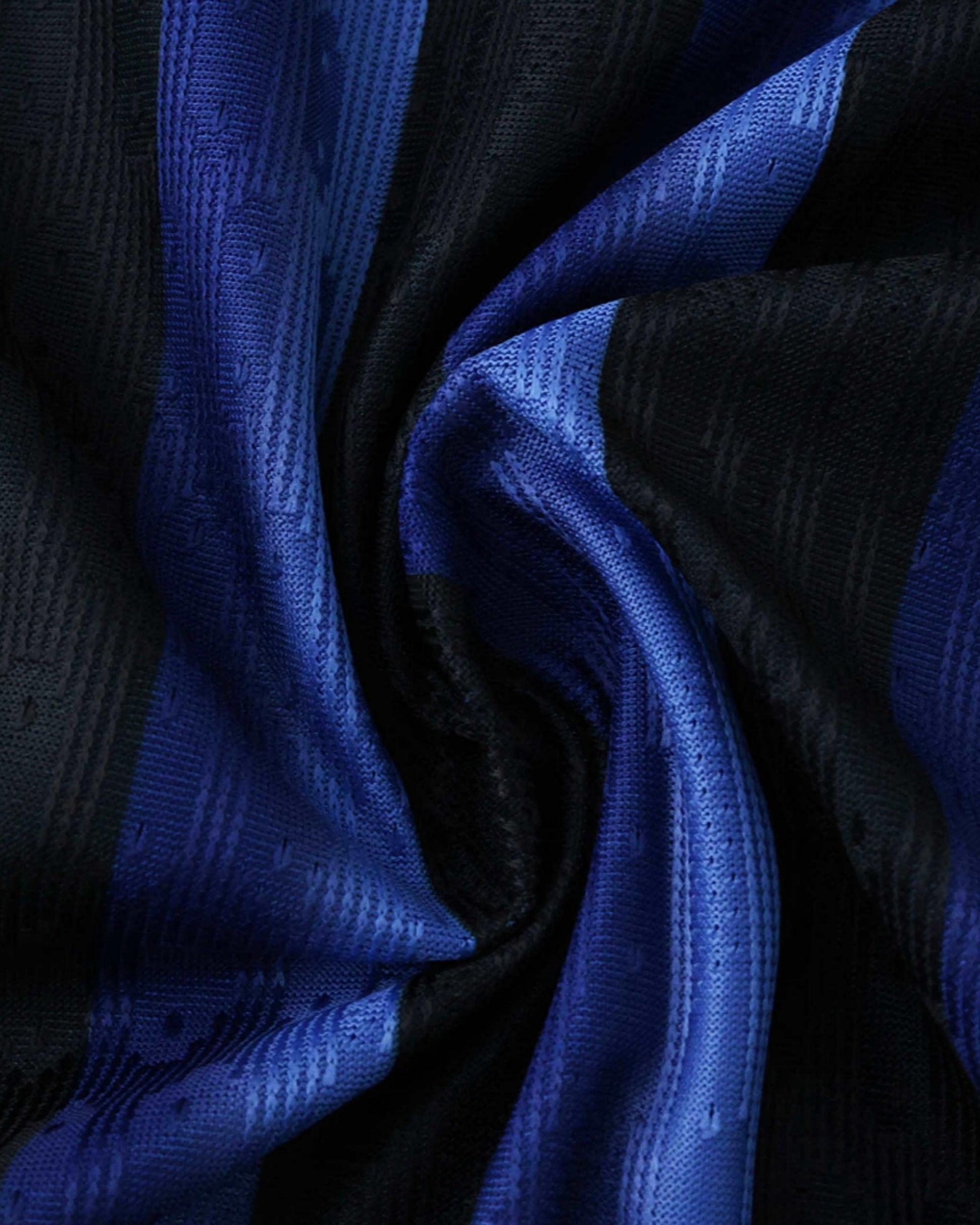 A close-up of a blue and black striped Inter Milan jersey with a textured fabric.