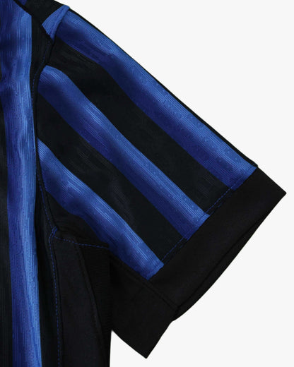 Close-up of a black and blue striped Inter Milan football jersey sleeve.