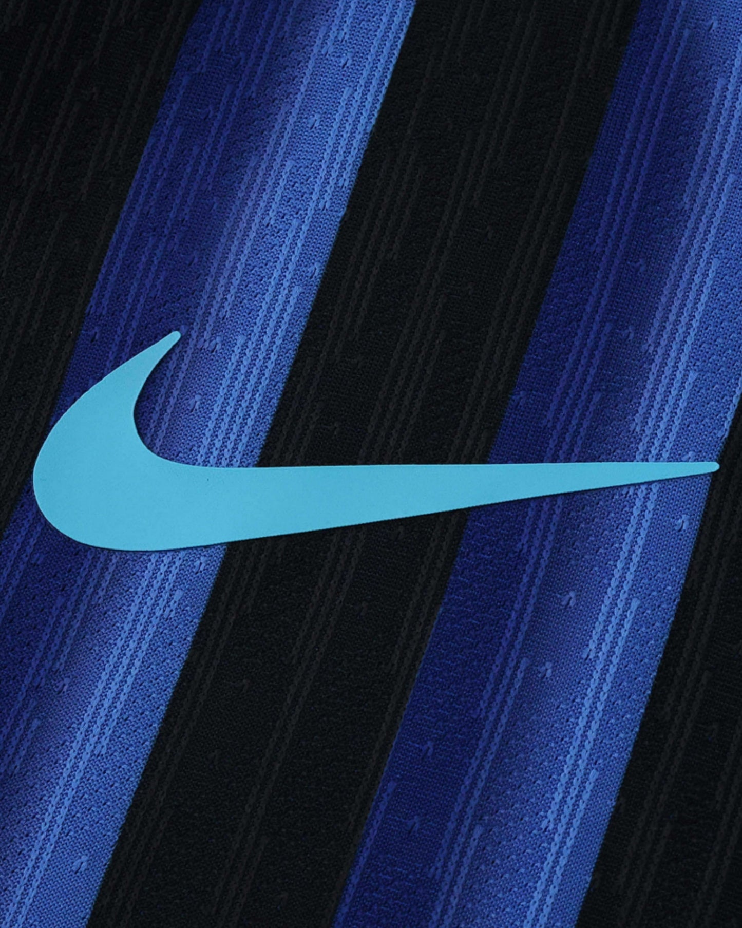 A light blue Nike swoosh logo is centered on a black and blue striped fabric.