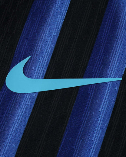 A light blue Nike swoosh logo is centered on a black and blue striped fabric.