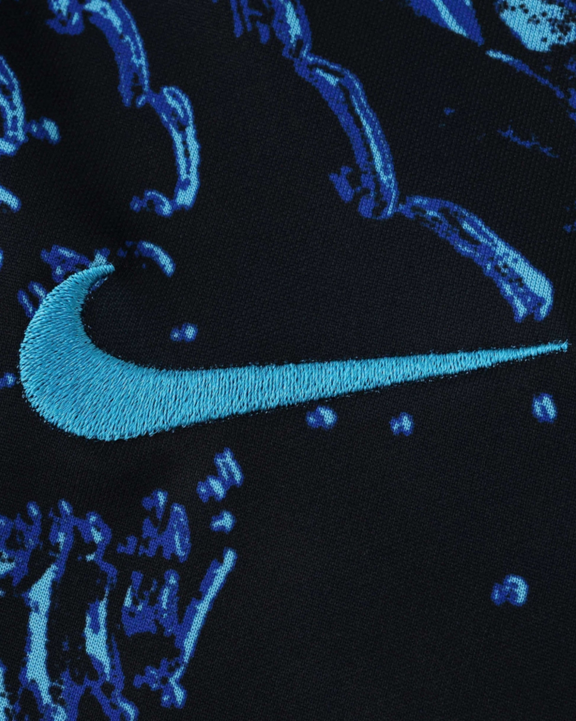 Black Inter Milan training shirt with a blue Nike logo and abstract blue pattern.