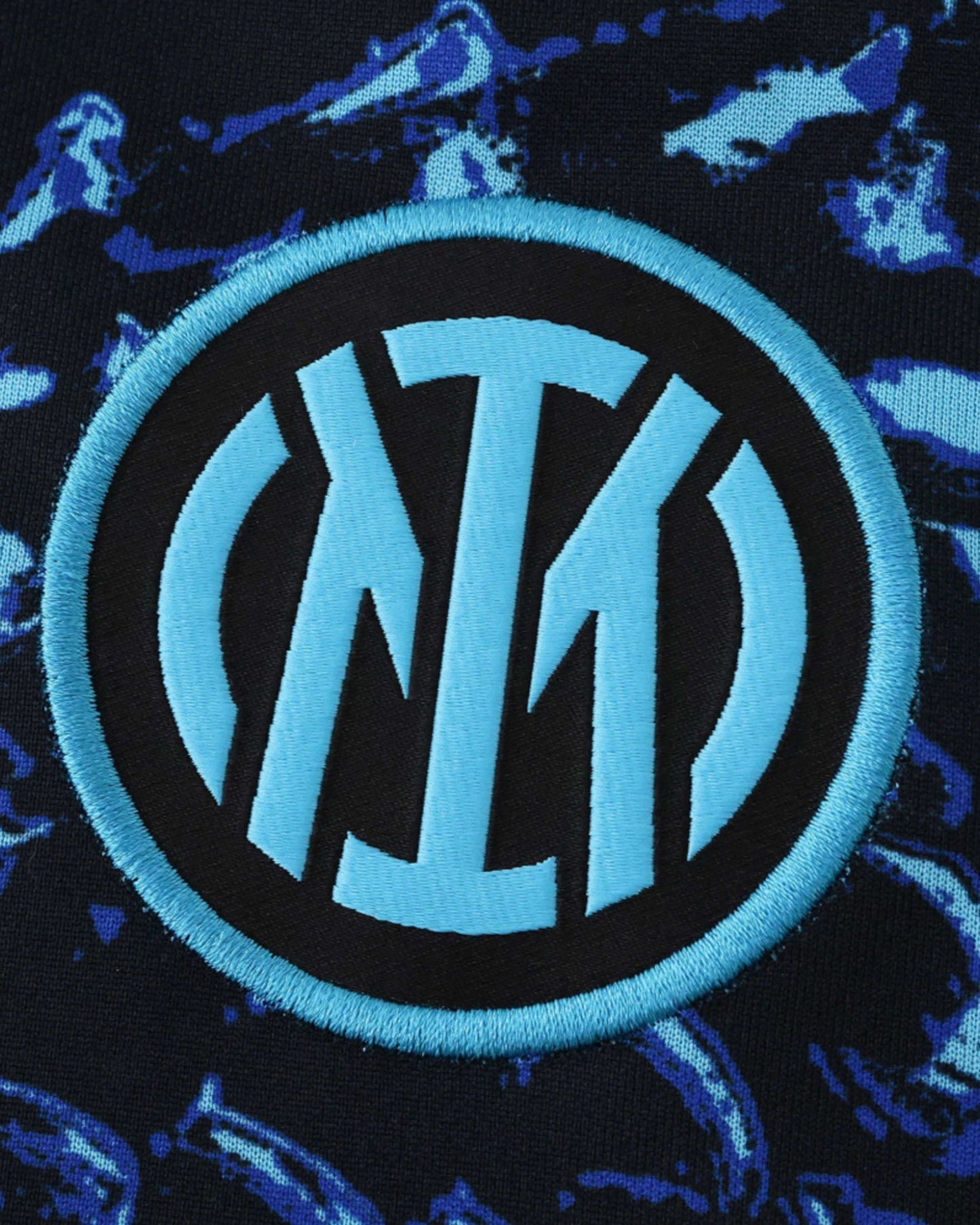 Inter Milan pre-match jersey with a blue and black abstract pattern and the club crest.