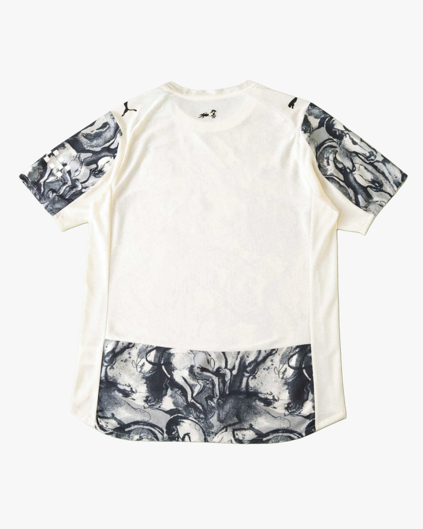 White Manchester City football jersey with horse graphic on sleeves and hem.