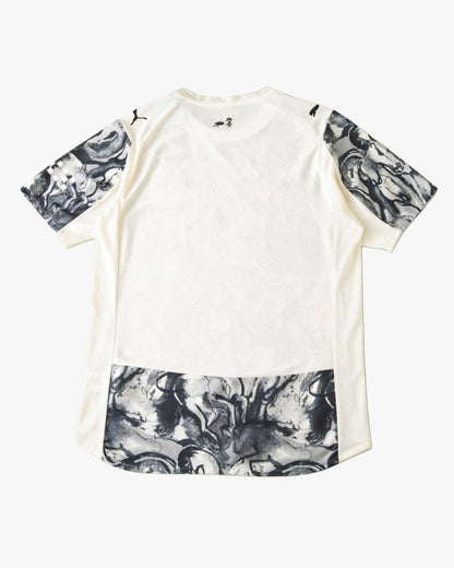 White Manchester City football jersey with horse graphic on sleeves and hem.