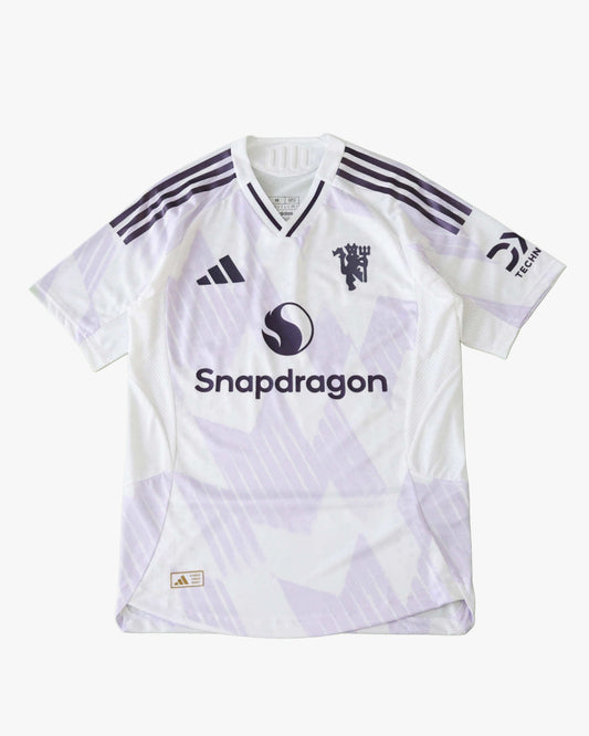 White Manchester United 2025/26 away jersey with purple accents and logos.