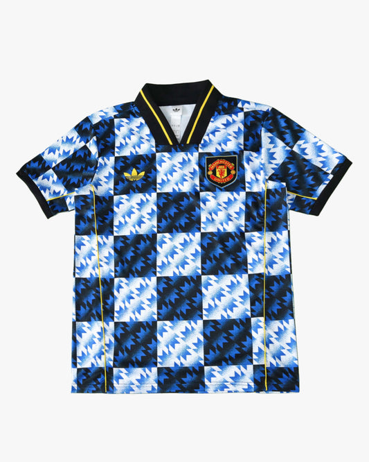 Manchester United x LFSTLR Premium Kit soccer jersey with a blue, black, and white geometric pattern.