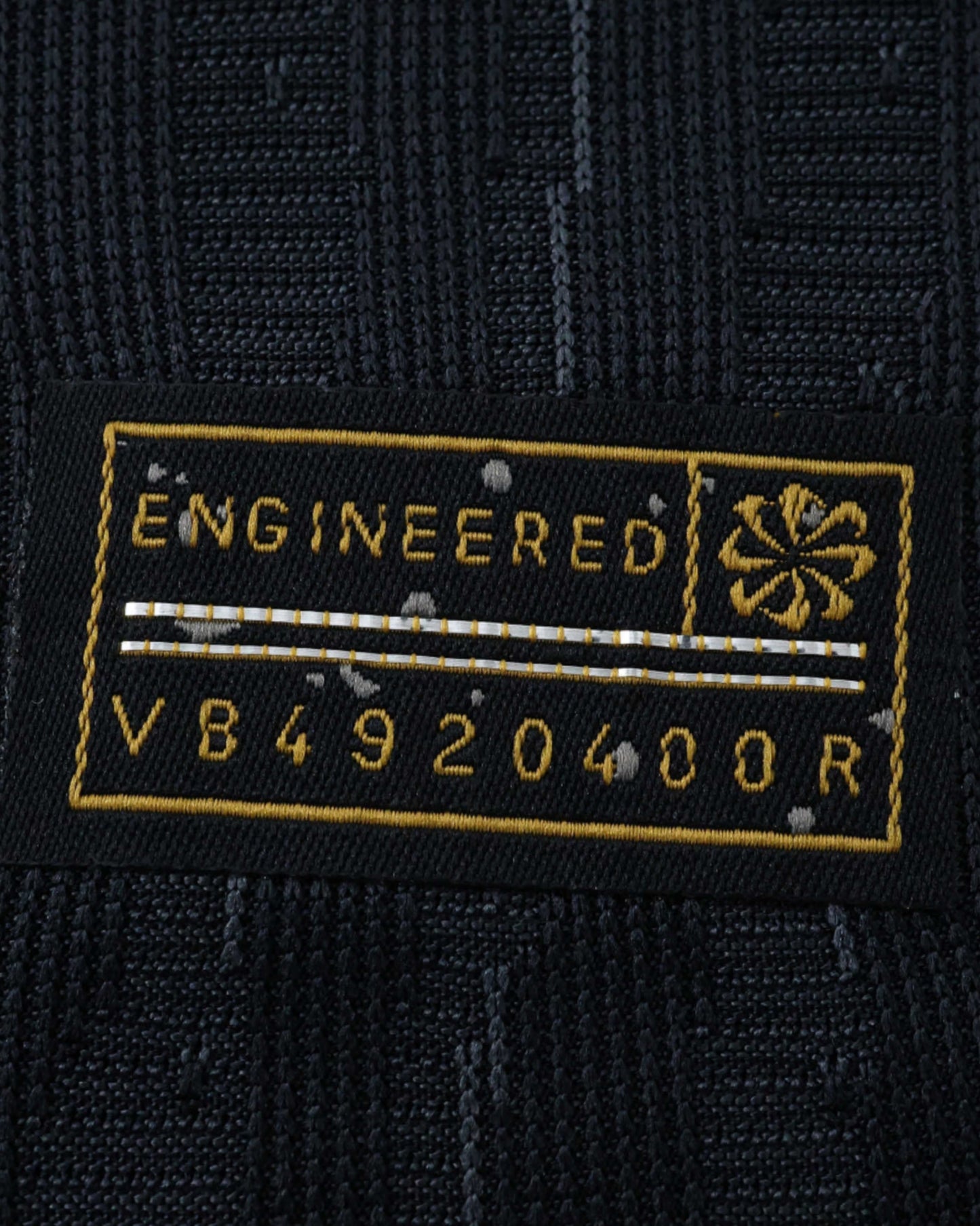 Black Nike jersey tag with "ENGINEERED" and code V84920400R.