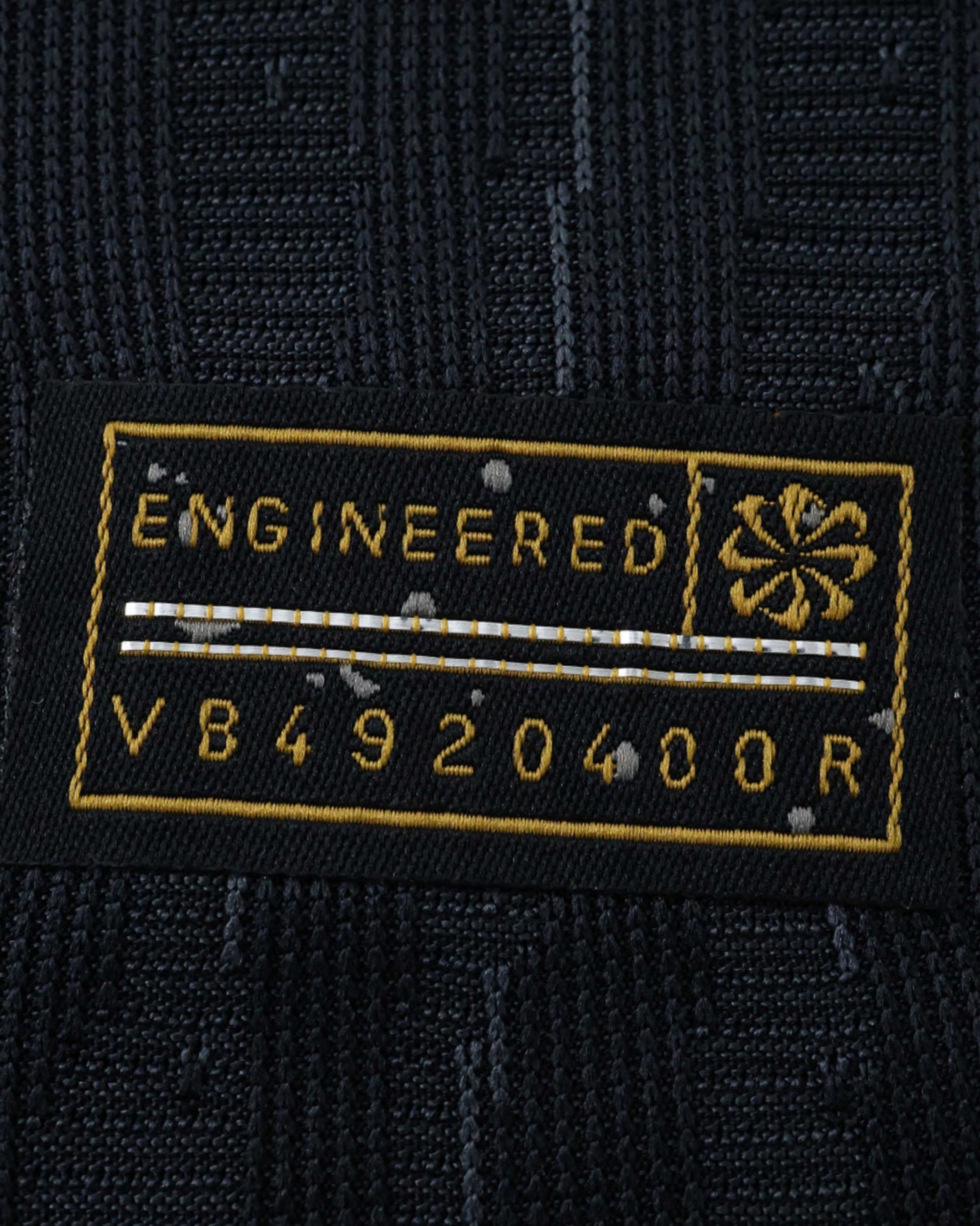Black Nike jersey tag with "ENGINEERED" and code V84920400R.