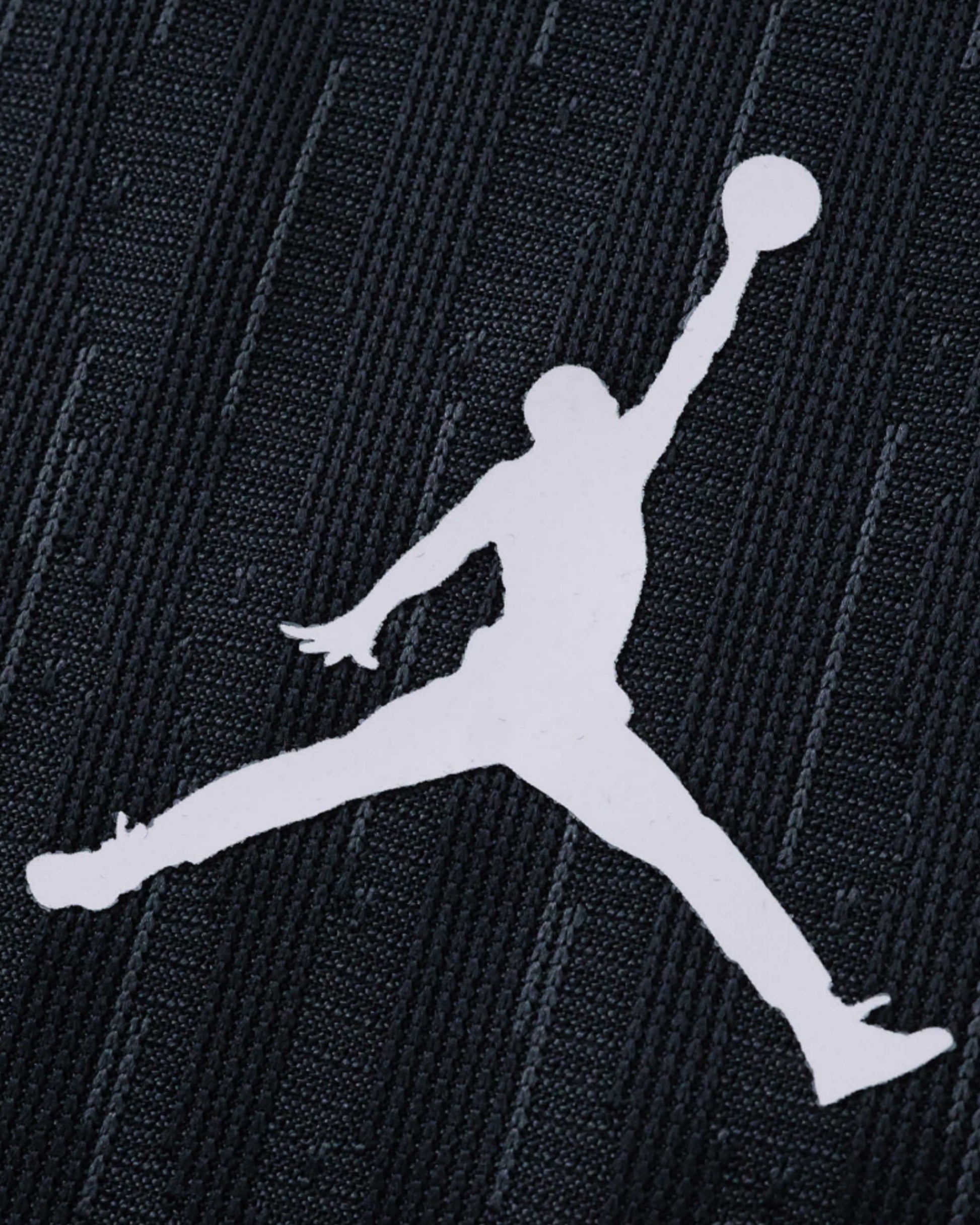 White Jumpman logo on a dark textured fabric.