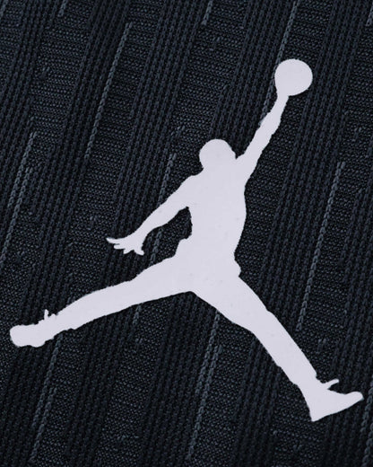 White Jumpman logo on a dark textured fabric.
