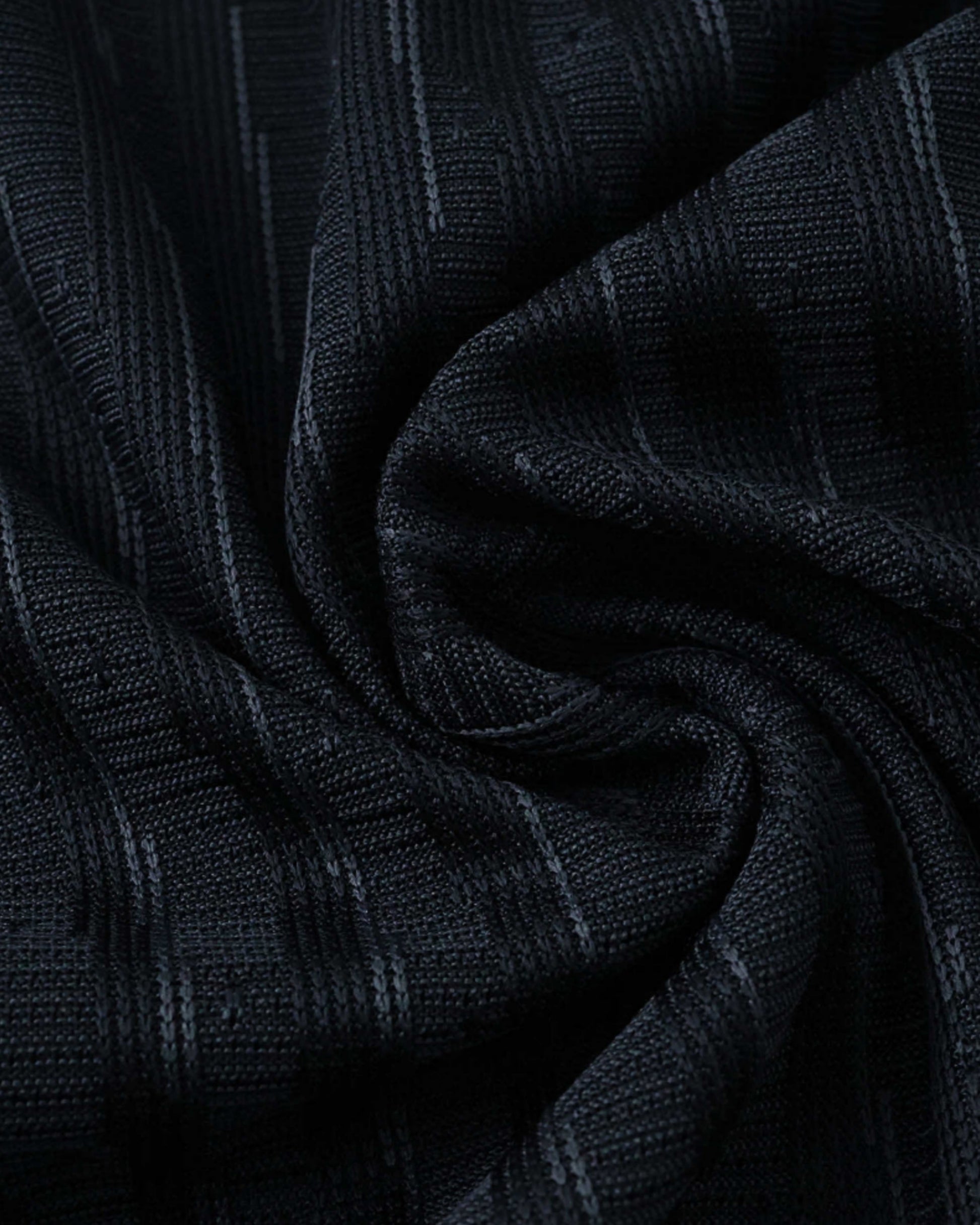 Black fabric with a subtle vertical stripe pattern.