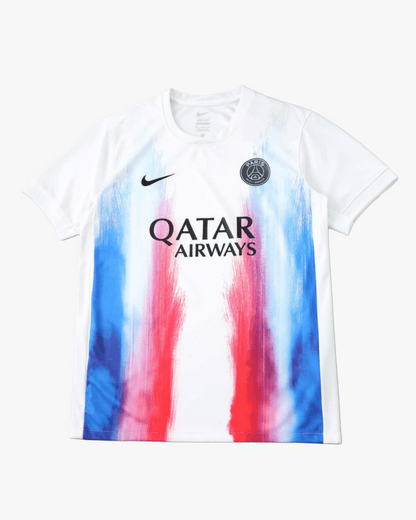 White Paris Saint-Germain pre-match training jersey with colorful brushstroke design.