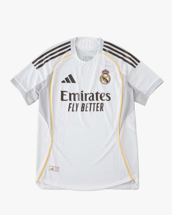 White Real Madrid 2025/26 home jersey with Adidas and Emirates branding.