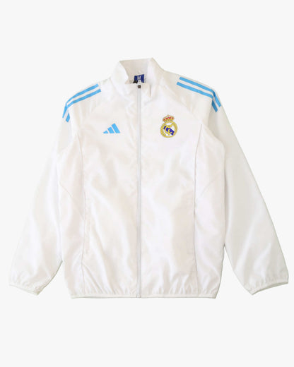 White Real Madrid training jacket with blue stripes and crest.