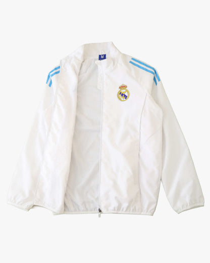 White Real Madrid training jacket with blue stripes and crest.