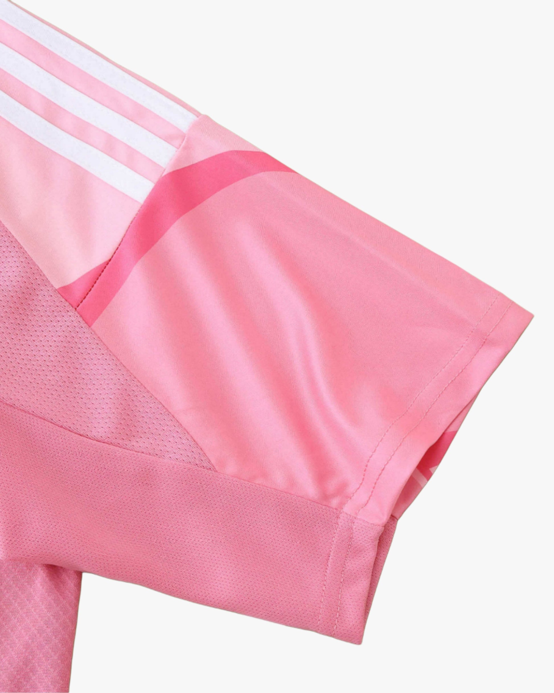 Pink Scotland away football shirt with white stripes on the sleeve.