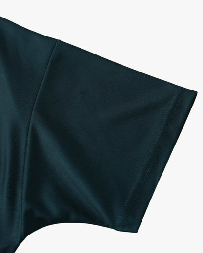Close-up of a dark teal short-sleeved football shirt sleeve with visible stitching.